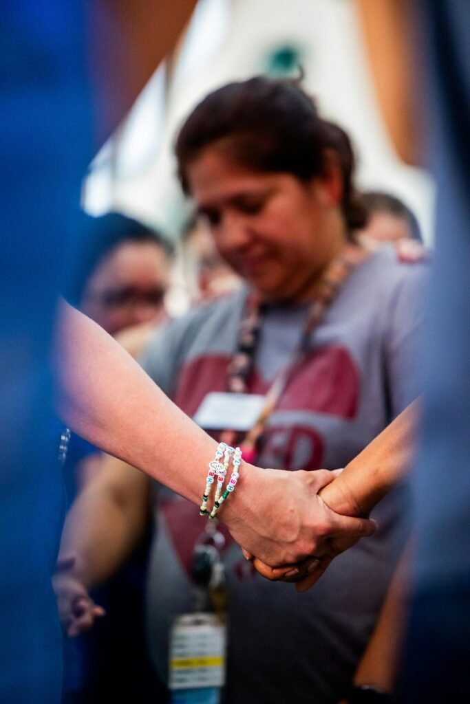 pexels photo 34520301 34520301 A diverse group of individuals holding hands in a supportive and united gesture, conveying unity.
